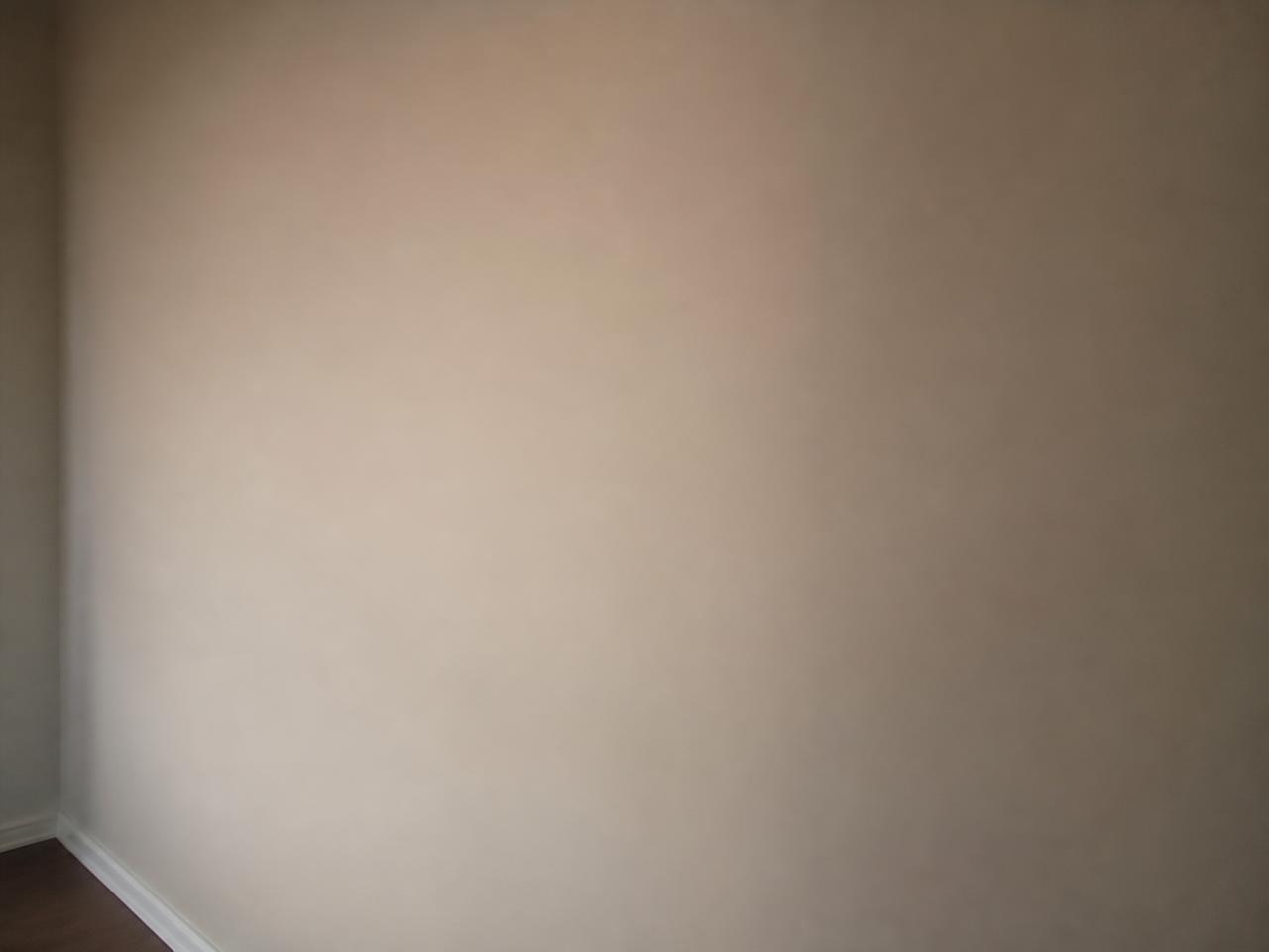 The same wall after a skim coat left a smooth, level, paint-ready finish.